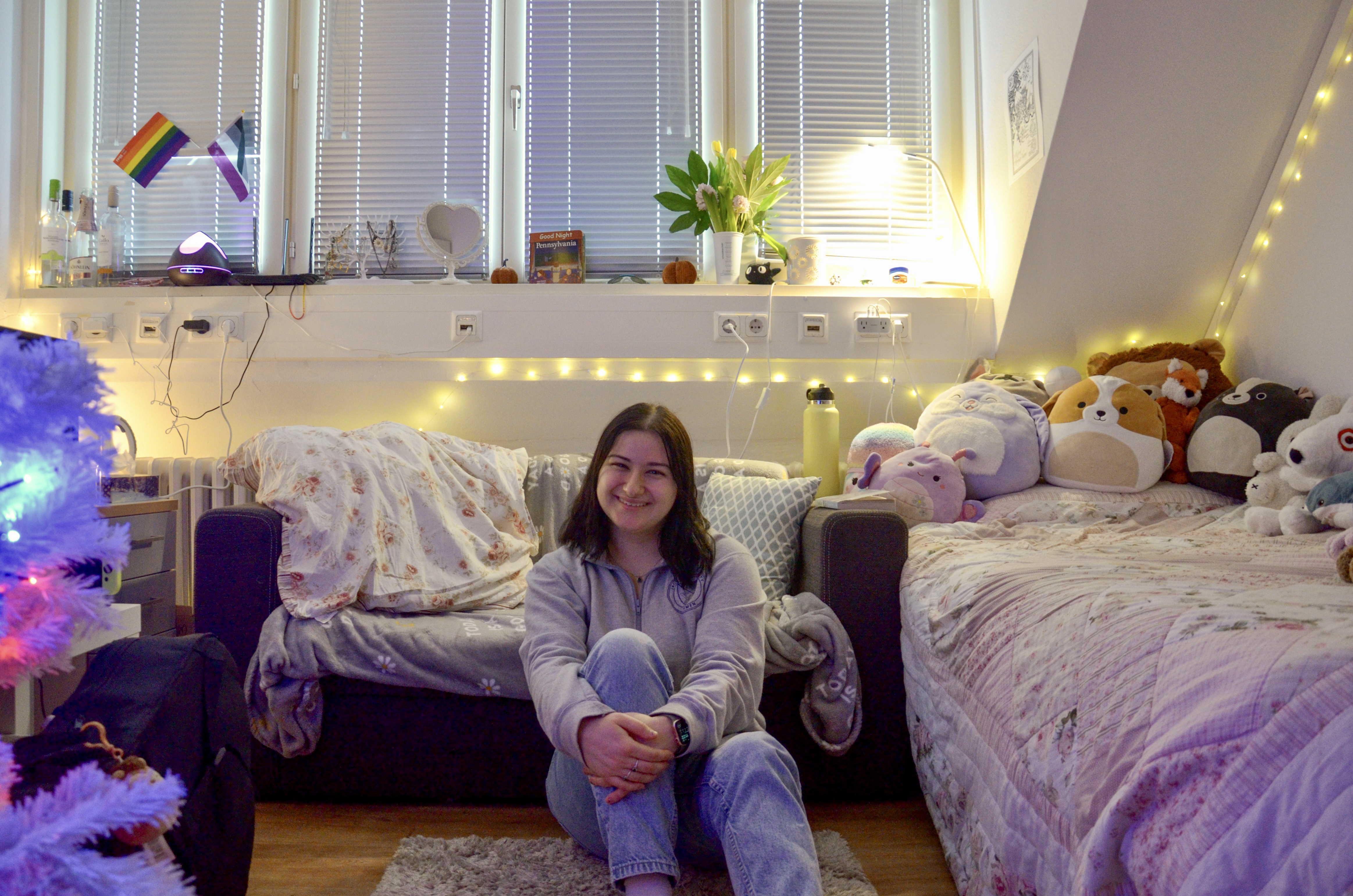 Student Bella sitting on the floor in her room