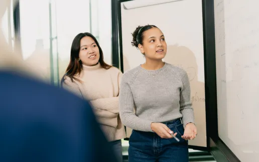 Students going through a presentation with a white board